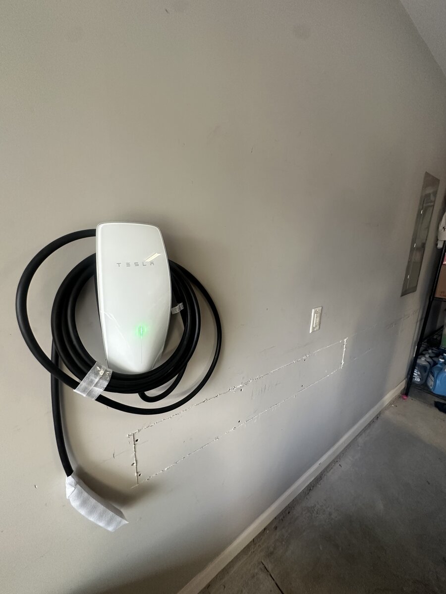 Tesla Wall Connector mounted at optimal charging height