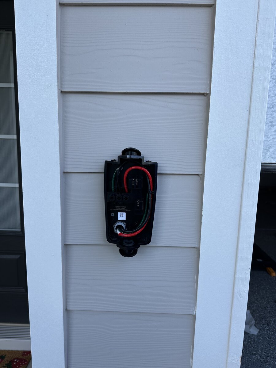Tesla EV charger with weatherproof exterior mounting